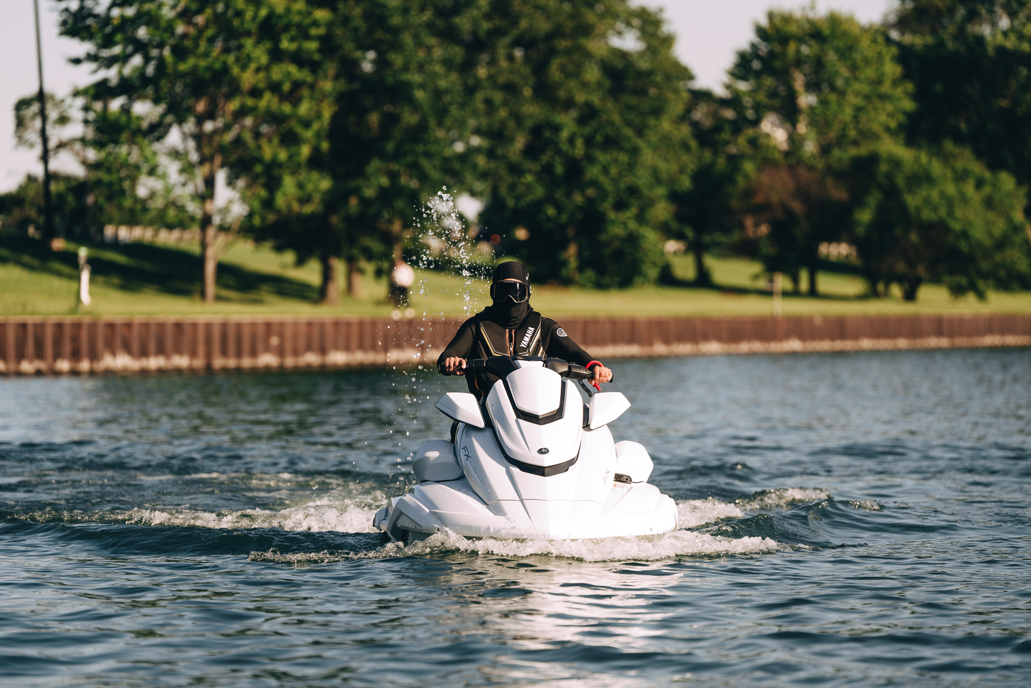 A Yamaha wave runner cutting a soft wake across open water