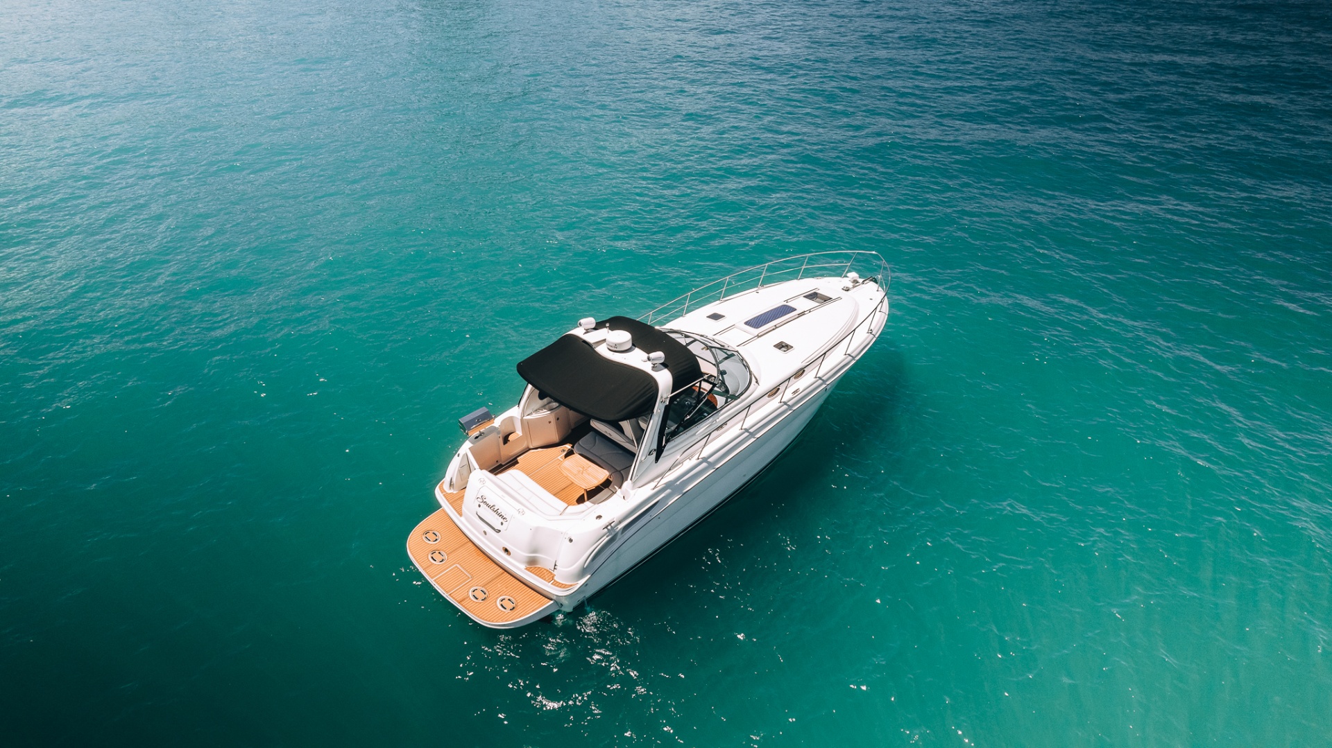 A private yacht seen from above on calm turquoise water